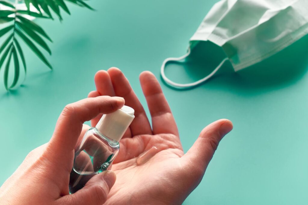 Hands of senior female with sanitizer,