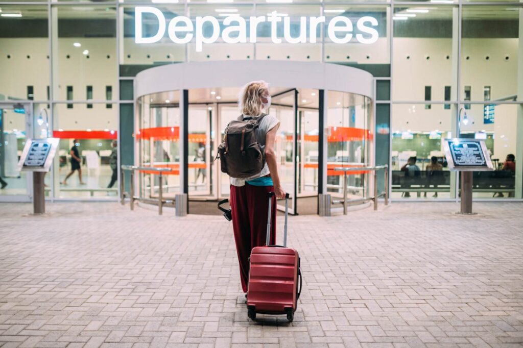 view a young woman in front of the airport