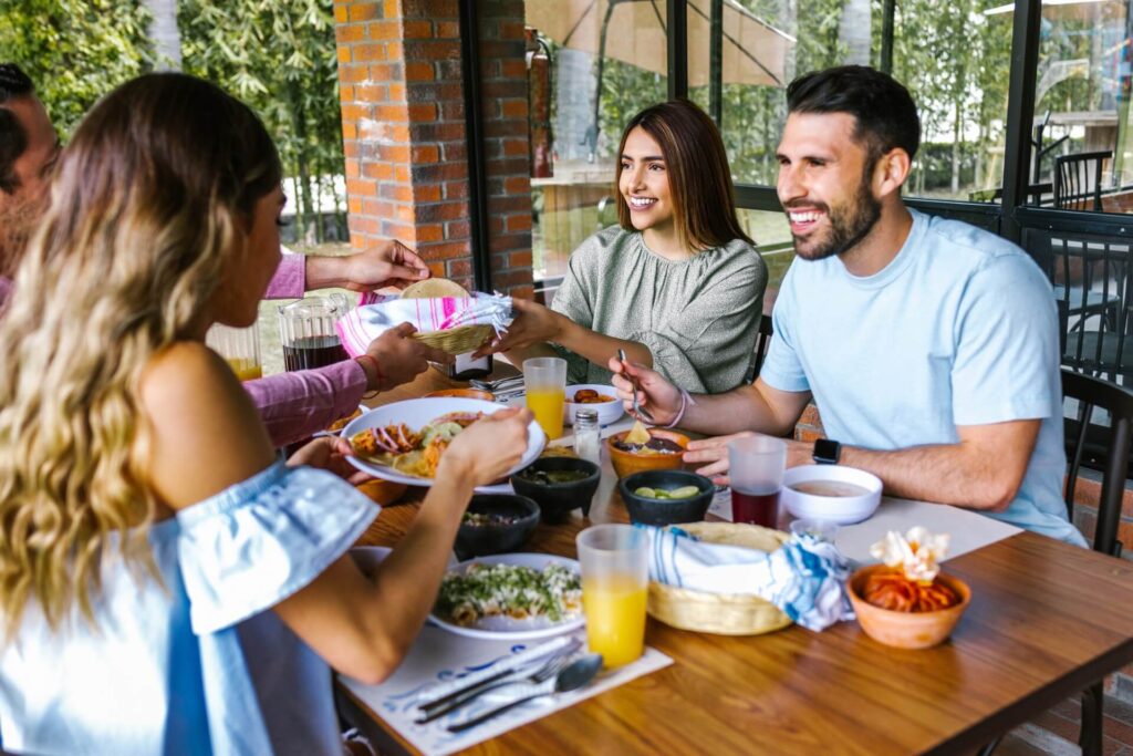 Group of latin friends eating mexican food